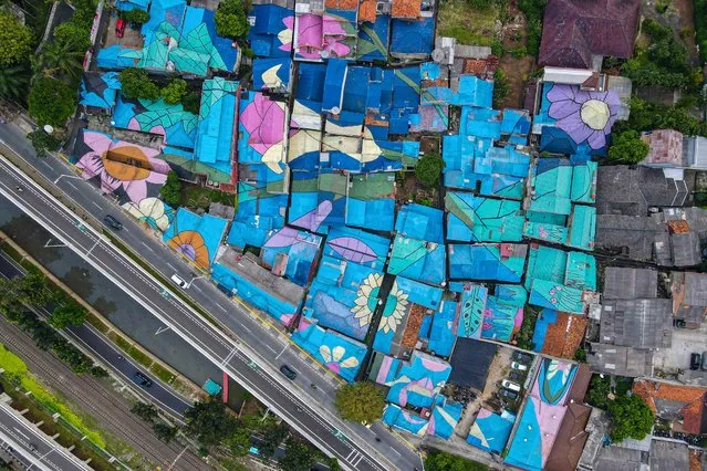 This aerial photo shows residents' homes painted by the local government in Jakarta on June 2, 2021. (Photo by Bay Ismoyo/AFP Photo)