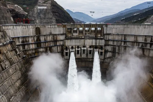 In this photo released by Xinhua News Agency, water is released from the dam of Baihetan hydropower station in Ningnan county, in southwestern China's Sichuan province on June 27, 2021. The Chinese government says it has turned on the first two generating units of the world's second-biggest hydroelectric dam. (Photo by Jiang Wenyao/Xinhua via AP Photo)
