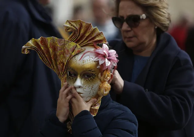 A child has a mask adjusted during carnival celebrations in Valletta, Malta, February 7, 2016. (Photo by Darrin Zammit Lupi/Reuters)