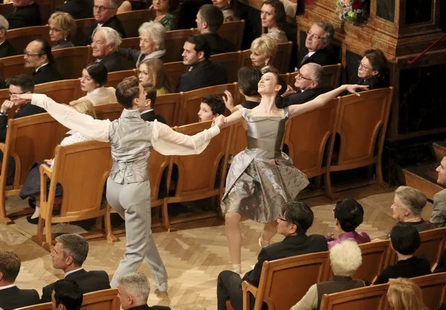 Young ballet dancers perform between the audience during the traditional New Year’s Concert of the Vienna Philharmonic Orchestra at the Golden Hall of the Musikverein in Vienna, Austria, Sunday, January 1, 2017. (Photo by Ronald Zak/AP Photo)