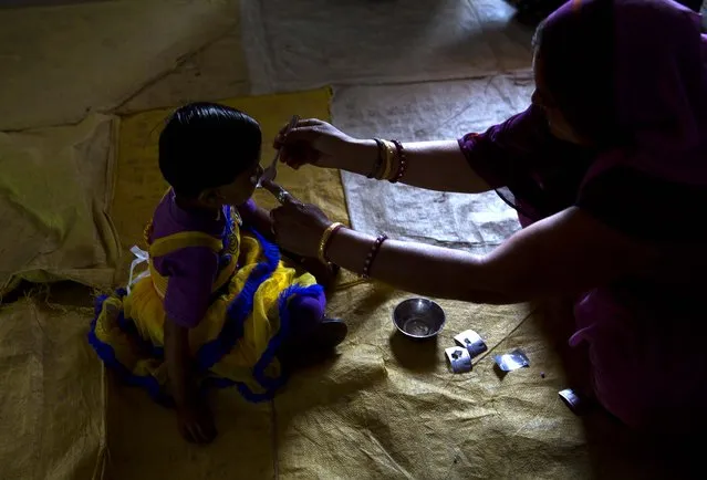 A health worker administers a deworming pill to a girl in a village in Neemrana , 123 kilometers (76.8 miles) from New Delhi, in the Indian state of Rajasthan, Wednesday, February 10, 2016. Millions of Indian children are taking part in a massive national deworming campaign to prevent parasitic worms from infecting their bodies and impairing their mental and physical development. The campaign is targeting 270 million children across the country with a second treatment planned next week for those left out on Wednesday, India’s Health Ministry said in a statement. (Photo by Manish Swarup/AP Photo)