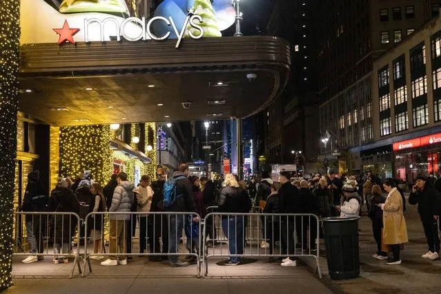 People wait in line outside Macy's before opening on “Black Friday” in New York City on November 24, 2023. (Photo by Yuki Iwamura/AFP Photo)