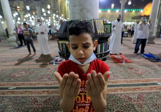 A Muslim worshipper boy takes part in evening prayers called “Tarawih” on Laylat al-Qadr or Night of Decree, inside Amr Ibn El-Aas Mosque on the holy fasting month of Ramadan in old Cairo, Egypt on May 8, 2021. (Photo by Amr Abdallah Dalsh/Reuters)