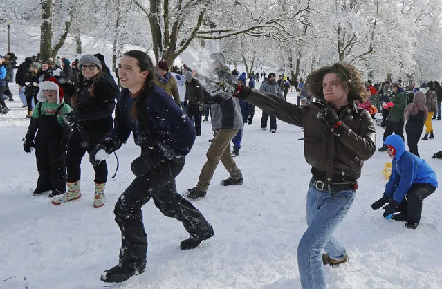 Several hundred people take part in a public snowball fight, Saturday, February 9, 2019, at Wright Park in Tacoma, Wash. Word of the friendly battle spread on social media Friday night and Saturday, as a winter storm that blanketed Washington state with snow moved south into Oregon and meteorologists warned that yet more winter weather was on the way. (Photo by Ted S. Warren/AP Photo)