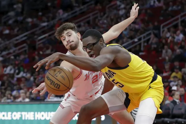 Indiana Pacers forward Jarace Walker, right, has the ball knocked away by Houston Rockets center Alperen Sengun during the first half of an NBA basketball game Tuesday, December 26, 2023, in Houston. (Photo by Michael Wyke/AP Photo)
