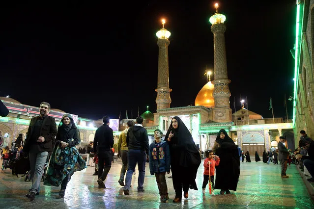 Iranians walk at the shrine of the Shiite Saint Imam Abdulazim in Shahr-e-Ray a day prior to the parliamentary and Experts Assembly elections in south of Tehran, Iran, Thursday, February 25, 2016. (Photo by Ebrahim Noroozi/AP Photo)