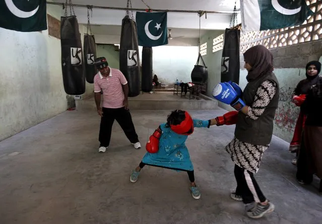 Arisha, 9, punches Misbah during an exercise session at the first women's boxing coaching camp in Karachi, Pakistan February 20, 2016. (Photo by Akhtar Soomro/Reuters)