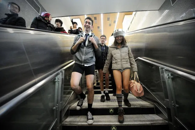 People take part in a 'No Pants Subway Ride' event in Beijing on January 12, 2014. Commuters in Hong Kong and Beijing braved public transport without trousers in the stunt, also celebrated in Australia's major cities, which has gone global since its first staging by the US group Improv Everywhere in New York in 2002. (Photo by Wang Zhao/AFP Photo)