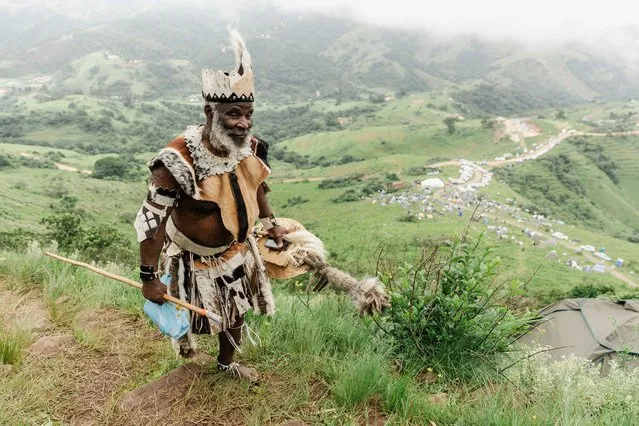 A follower of the Nazareth Baptist Church dressed in a traditional attire from the Ekuphakameni group, also known as the Shembe Church, climbs the Nhlangakazi Holy Mountain in Ndwedwe, 85 kilometres north of Durban, on January 7, 2024. The devotees climb the mountain as part of their annual 10 day pilgrimage. The church was founded in 1913 and is one of the largest African traditionalist church in Africa. They walk up to 68kms barefoot praying, worshipping, singing, dancing and camping on their four weeks stay at the mountain. The Shembe Church is the oldest independent indigenous Church in Southern Africa. (Photo by Rajesh Jantilal/AFP Photo)
