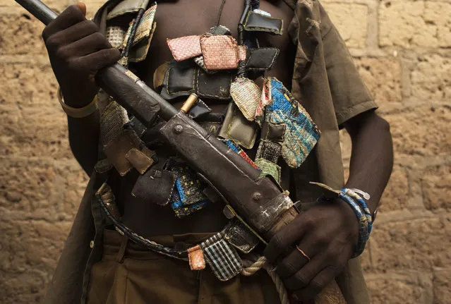 An anti-balaka militiaman poses for a photograph on the outskirts of the capital of the Central African Republic Bangui January 15, 2014. (Photo by Siegfried Modola/Reuters)