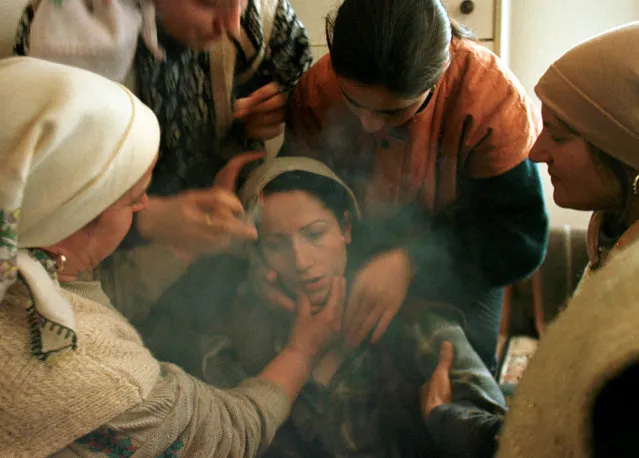 An ethnic Albanian woman cries at her husband's funeral in Kosovo, January 1999. (Photo by Yannis Behrakis/Reuters)