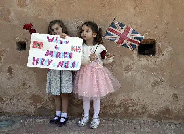 Children wait for the arrival of Britain's Prince Harry and Meghan, Duchess of Sussex at the Andalusian Gardens in Rabat, Morocco, Monday, February 25, 2019. The Duke and Duchess of Sussex are on a three day visit to the country. (Photo by Facundo Arrizabalaga/Pool Photo via AP Photo)