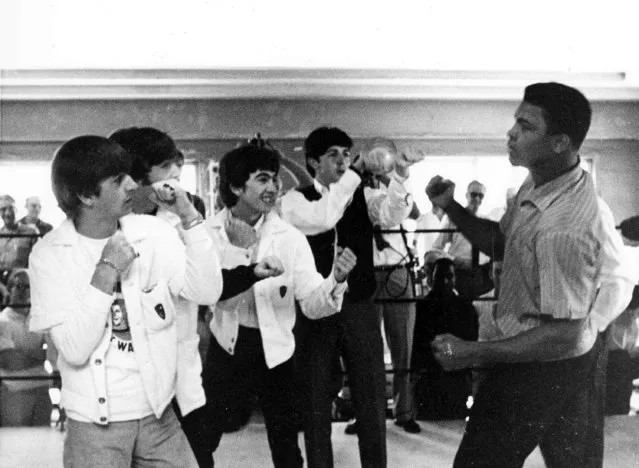 The Beatles, from left, Ringo Starr, John Lennon, George Harrison, and Paul McCartney spar up to Cassius Clay while visiting the heavyweight contender at his training camp in Miami Beach, Fla., February 18,1964. (Photo by AP Photo/stf)