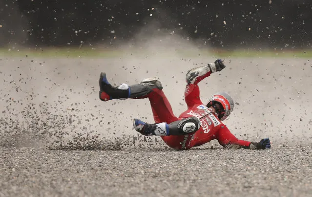 In this March 30, 2019 photo, Andrea Dovizioso of Italy falls from his bike during a Moto GP free practice run at the circuit in Termas de Rio Hondo, Argentina. Despite the fall Dovizioso raced in the third pole position on Sunday and finished in third place. (Photo by Nicolas Aguilera/AP Photo)