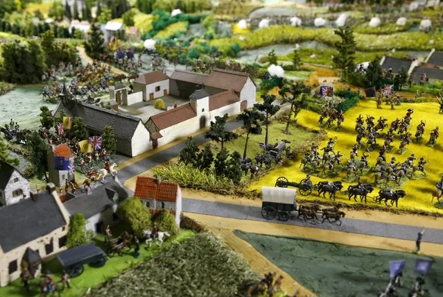 The Mont-Saint-Jean farm is seen near figurines representing soldiers of the British army on a 40-square-metre miniature model of the June 18, 1815 Waterloo battlefield, in Diest, Belgium, in this picture taken on April 29, 2015. Waterloo enthusiast Willy Smout said he spent 40,000 hours and around 150,000 euros over the past 40 years, to recreate the battlefield as closely as possible in a purpose-built room in his house. (Photo by Francois Lenoir/Reuters)