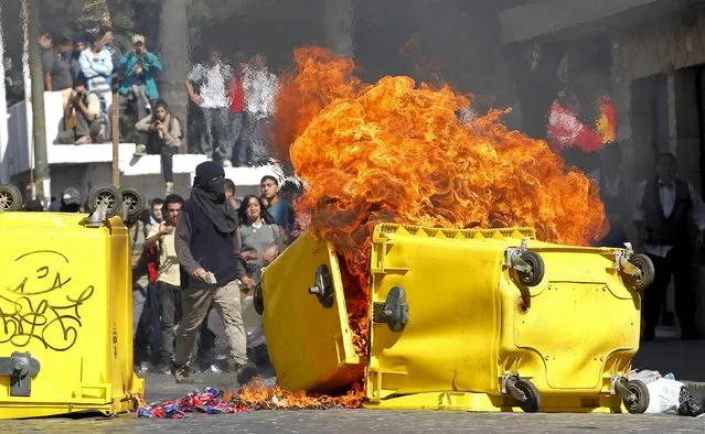 Demonstrators add to a bonfire during a rally named “March for the recovery of water and life”, demanding for the nationalisation of water resources, in Valparaiso April 22, 2015. (Photo by Rodrigo Garrido/Reuters)