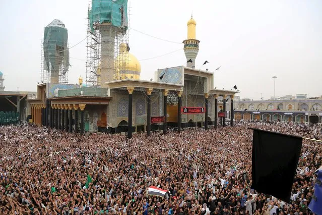 Shi'ite pilgrims gather at Imam Moussa al-Kadhim shrine to mark his death anniversary in Baghdad's Kadhimiya district, May 14, 2015. Every year, thousands of Shi'ite pilgrims gather at the shrine to commemorate the death of Imam Moussa al-Kadhim, one of the 12 imams of Shi'ite, who was imprisoned for four years and poisoned by then-ruler Harun al-Rashid in 795 AD. (Photo by Reuters/Stringer)