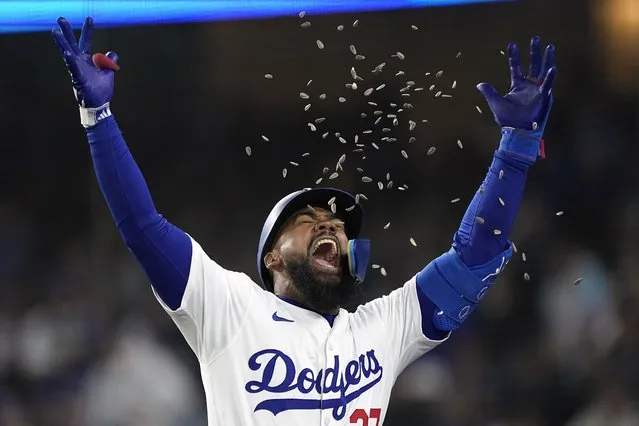 Los Angeles Dodgers' Teoscar Hernández celebrates as he is hit by sunflower seeds thrown by Mookie Betts after hitting a two-run home run during the third inning of a baseball game against the San Diego Padres Friday, April 12, 2024, in Los Angeles. (Photo by Mark J. Terrill/AP Photo)