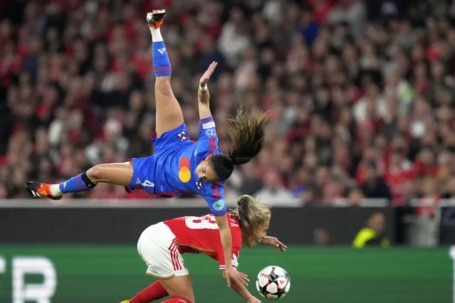Benfica's Lucia Alves, bottom, challenges for the ball with Lyon's Selma Bacha during the women's Champions League quarterfinals, first leg, soccer match between SL Benfica and Olympique Lyonnais at the Luz Stadium, in Lisbon, Tuesday, March 19, 2024. (Photo by Armando Franca/AP Photo)