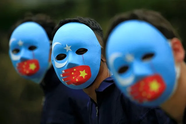 Activists take part in a protest against China's treatment towards the ethnic Uyghur people and calling for a boycott of the 2022 Winter Olympics in Beijing, at a park Jakarta, Indonesia, January 4, 2022. (Photo by Willy Kurniawan/Reuters)