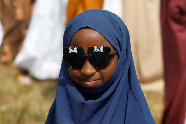 A girl poses for a photograph as Muslim faithful attend the Eid al-Fitr prayers, marking the end of Ramadan, in Lagos, Nigeria on April 10, 2024. (Photo by Temilade Adelaja/Reuters)