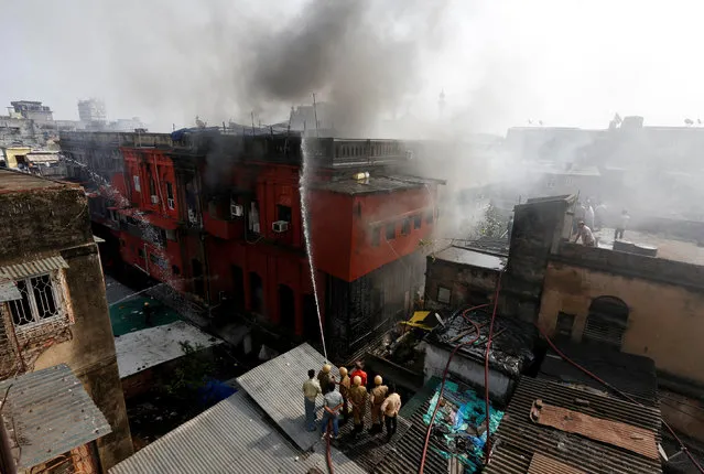 Firefighters extinguish a fire at a three-storey building in the crowded Burrabazar market area in Kolkata, India February 28, 2017. (Photo by Rupak De Chowdhuri/Reuters)