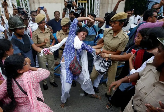 Police detain a demonstrator during a protest against the deaths of children who have died this month in Bihar, from encephalitis, commonly known as brain fever, in Kolkata, June 24, 2019. (Photo by Rupak De Chowdhuri/Reuters)