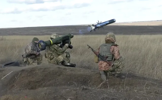 In this image taken from footage provided by the Ukrainian Defense Ministry Press Service, a Ukrainian soldiers use a launcher with US Javelin missiles during military exercises in Donetsk region, Ukraine, Wednesday, January 12, 2022. President Joe Biden has warned Russia's Vladimir Putin that the U.S. could impose new sanctions against Russia if it takes further military action against Ukraine. (Photo by Ukrainian Defense Ministry Press Service via AP Photo)