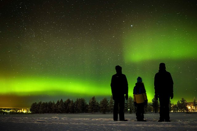 The northern lights (aurora borealis) illuminate the sky above the village of Akaslompolo in Kolari, beyond the Arctic Circle, Finnish Lapland, on Sunday, February 11, 2024.(Photo by Laurent Gillieron/Keystone)