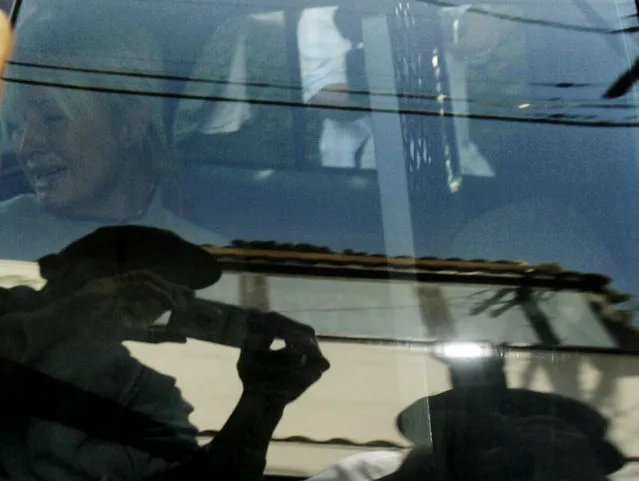 In this Friday, June 8, 2007 file photo, Paris Hilton is transported in a police car from her home to court by the Los Angeles County Sheriff's Department in Los Angeles. As she was taken to jail for driving violations, this photo was made on the 35th anniversary of the day Ut made the “Napalm Girl” picture in Vietnam. (Photo by Nick Ut/AP Photo)