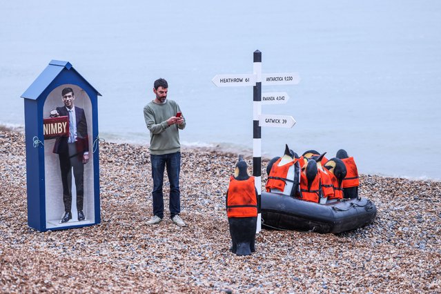 Anonymous art collective Beyond in East Sussex on May 16, 2024 draw attention with a beach installation, protesting the government's unworkable and inhumane Rwanda plan to stop small boats. This installation coincides with Endangered Species Day and features a small boat carrying penguins in life jackets approaching a life-sized Rishi Sunak denying them entry to the beach and instead directing them towards a sign to Rwanda. (Photo by Paul Quezada=Neiman/Alamy Live News)
