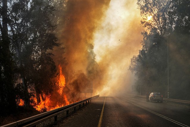 Flames seen at the side of a road, amid ongoing cross-border hostilities between Hezbollah and Israeli forces, close to the Israel border with Lebanon, in northern Israel on June 4, 2024. (Photo by Ayal Margolin/Reuters)