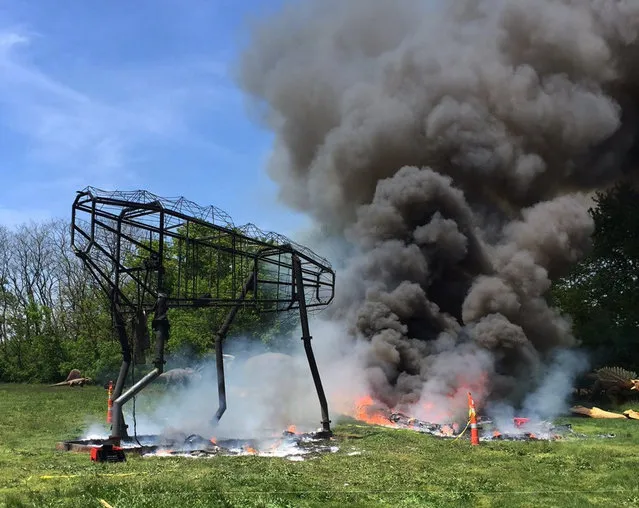 This photo provided by the Leonia, N.J., Police Department shows a fire that destroyed a 90-foot animatronic dinosaur at Overpeck County Park in Leonia, N.J., Thursday, May 12, 2016. (Photo by Leonia Police Department via AP Photo)