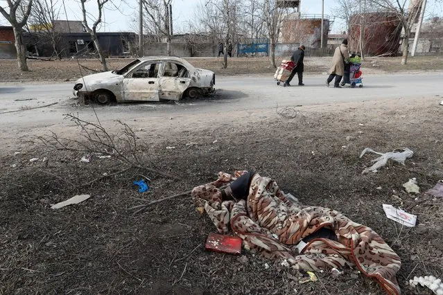 A view shows the body of a person killed in the besieged southern port of Mariupol, Ukraine on March 20, 2022. (Photo by Alexander Ermochenko/Reuters)