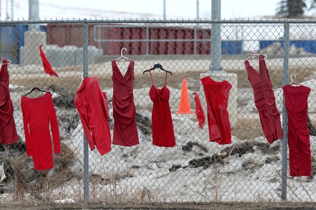 Red dresses, hung in honour of missing and murdered Indigenous women, girls and two-spirit individuals, line fences at Brady Road Resource Management Facility, where the body of 33-year-old Linda Mary Beardy of Lake St. Martin First Nation was discovered, in Winnipeg, Manitoba, Canada on April 4, 2023. (Photo by Shannon Vanraes/Reuters)