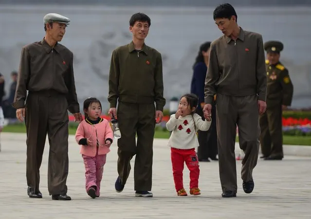 Families walk on the grounds of the Kumsusan Palace of the Sun, which holds the preserved remains of former leaders Kim Il-sung, and Kim Jong -il. (Photo by Gavin John/Mediadrumworld.com)