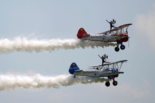 AeroSupaBatics' wingwalkers perform during the IWM Duxford Air Show in Cambridgeshire, England, on Sunday, June 2, 2024. (Photo by Joe Giddens/PA Wire via AP Photo)