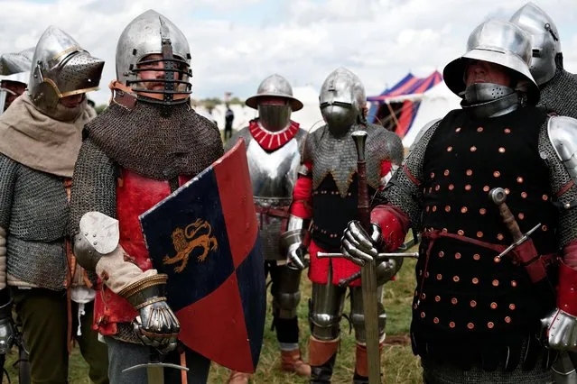 People wear armor as they attend a reenactment of the Battle of Agincourt, in Agincourt, northern France, Saturday, July 25, 2015. (Photo by Thibault Camus/AP Photo)