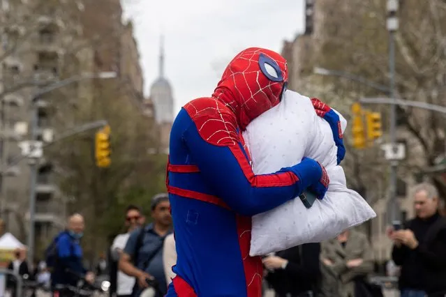 A man dressed as Spider-Man holds a pillow during the International Pillow Fight Day at Washington Square Park in Manhattan, New York, U.S., April 16, 2022. (Photo by Jeenah Moon/Reuters)