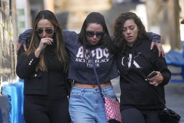 Friends and relatives of Danilo Santos Romano leave Penha Cemetery after his burial in Sao Paulo, Brazil, Monday, August 12, 2024. Romano was the pilot of the plane that crashed into the backyard of a home in the city of Vinhedo on Aug. 9. (Photo by Andre Penner/AP Photo)