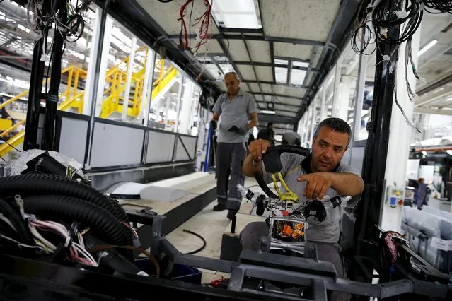 Employees work at the assembly line of the MAN Bus Production Center in Ankara, Turkey, July 29, 2015. (Photo by Umit Bektas/Reuters)