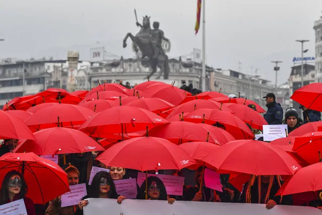 Macedonian s*x workers carrying red umbrellas walk over the Old Stone Bridge at the main square during a rally to mark the International Day to End Violence Against s*x Workers, in Skopje, Republic of North Macedonia, 17 December 2019. (Photo by Georgi Licovski/EPA/EFE)
