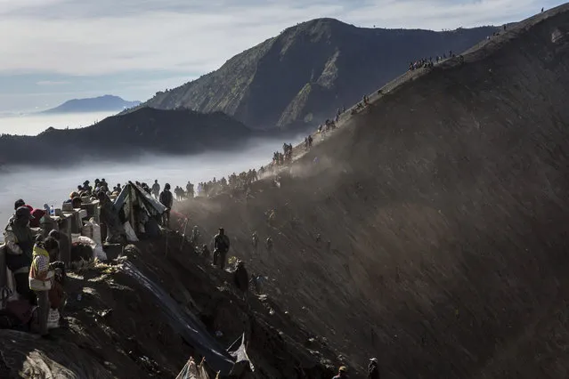 Tenggerese worshippers gather at the crater of Mount Bromo during the Yadnya Kasada Festival on August 01, 2015 in Probolinggo, East Java, Indonesia. The festival is the main festival of the Tenggerese people and lasts about a month. (Photo by Ulet Ifansasti/Getty Images)