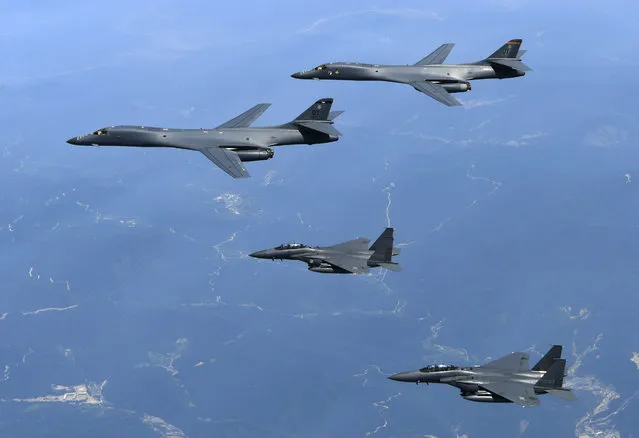 In this Tuesday, June 20, 2017 photo provided by South Korean Defense Ministry, U.S. Air Force B-1B bombers, top, and second from top, and South Korean fighter jets F-15K fly over the Korean Peninsula, South Korea. The United States flew two supersonic bombers over the Korean Peninsula on Tuesday in a show of force against North Korea, South Korean officials said. (Photo by South Korean Defense Ministry via AP Photo)