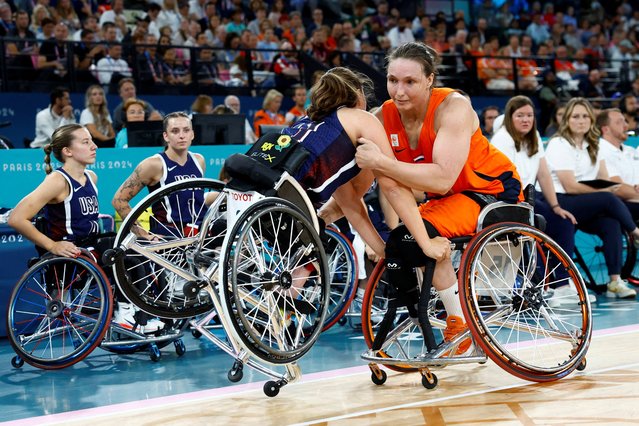 Mariska Beijer of Netherlands stops Kaitlyn Eaton of United States from falling during the women's wheelchair basketball gold medal match between Netherlands and United States in Paris 2024 Paralympics on September 8, 2024. (Photo by Carlos Garcia Rawlins/Reuters)