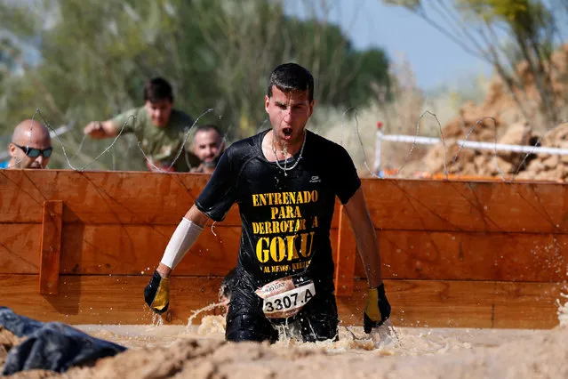 A participant competes in the Mud Day Race extreme run competition at El Goloso military base, outside Madrid, Spain, June 11, 2016. (Photo by Juan Medina/Reuters)