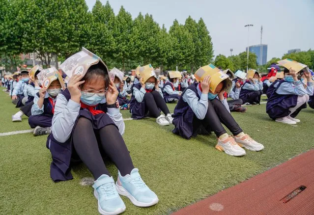 Primary school students attend an emergency evacuation drill on China's national day for disaster prevention and relief on May 12, 2022 in Hefei, Anhui Province of China. China's national day for disaster prevention and relief falls on May 12 every year. (Photo by Ge Qingzhao/VCG via Getty Images)