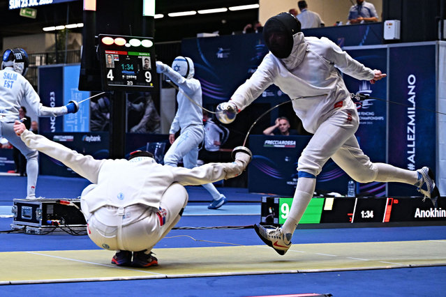 Serbian Jovan Jovanovic (L) competes against Russian Vadim Anokhin during their Men's individual epee qualifying bout as part of the fencing event of the FIE Fencing World Championships at the Fair Allianz MI.CO (Milano Convegni) in Milan, on July 23, 2023. (Photo by Andreas Solaro/AFP Photo)