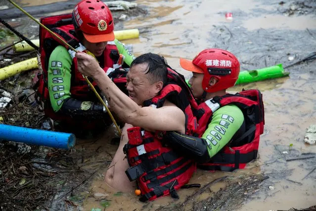 Rescuers evacuate stranded people in flood water in Songxi County of Nanping, southeast China's Fujian Province, June 18, 2022 A level I emergency response for the city of Nanping was activated on Saturday for preparedness against severe flooding. (Photo by China Daily via Reuters)