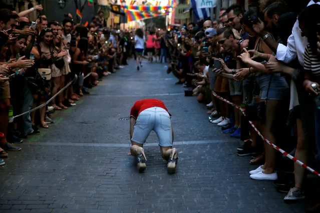 A competitor falls during the annual race on high heels during Gay Pride celebrations in the quarter of Chueca in Madrid, Spain, June 30, 2016. (Photo by Susana Vera/Reuters)